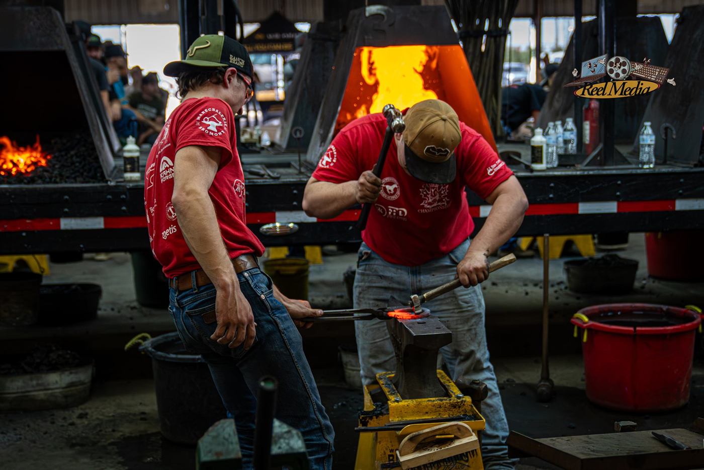 A two-person team working hot iron together