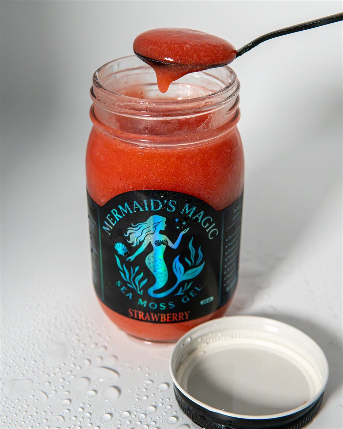 Mermaids Magic Strawberry sea moss gel on a spoon